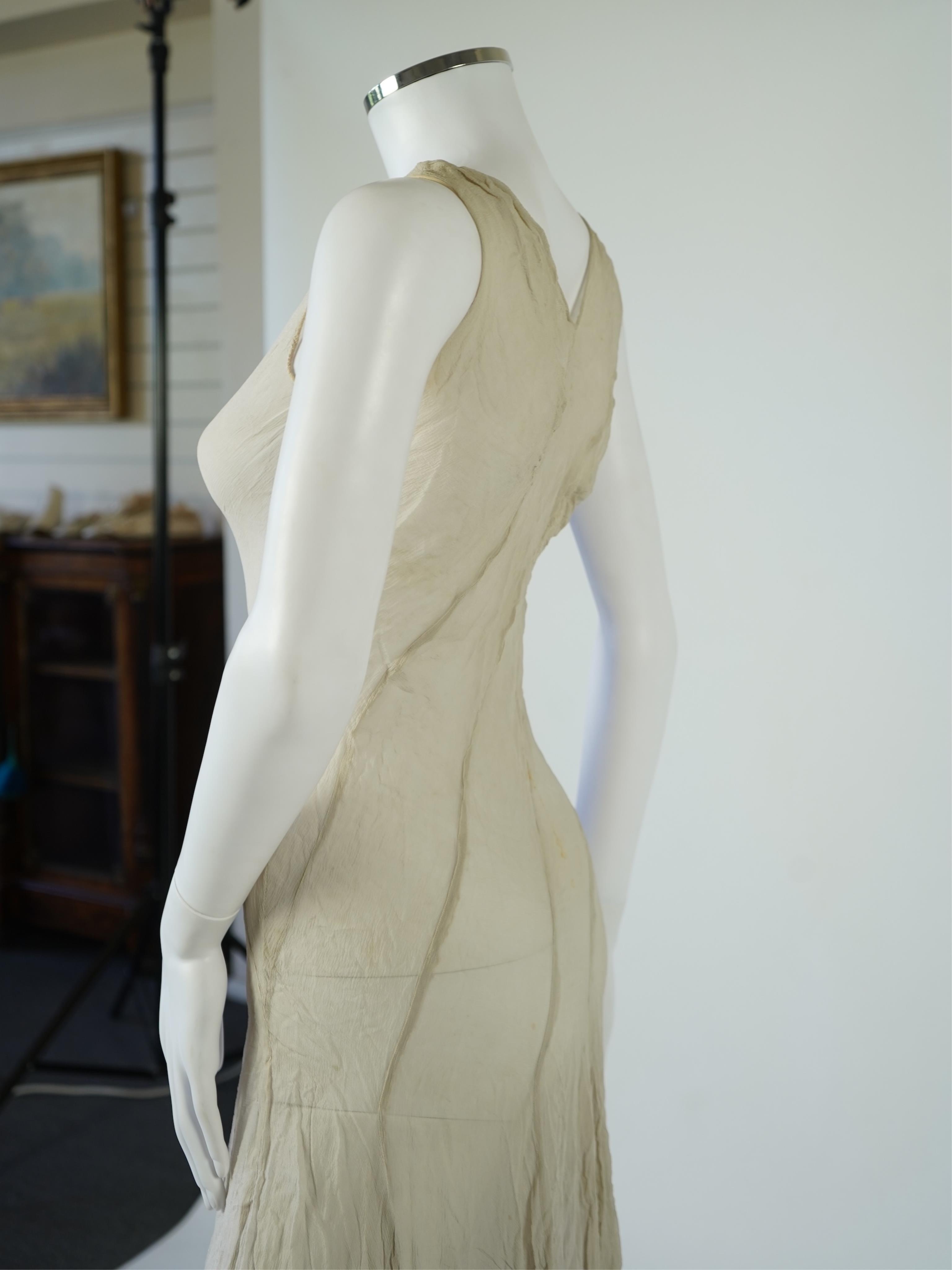 A 1930's grey chiffon bias cut ladies evening dress. 120cm long. Condition - has a small hole at the back and a light mark possibly removed with washing.